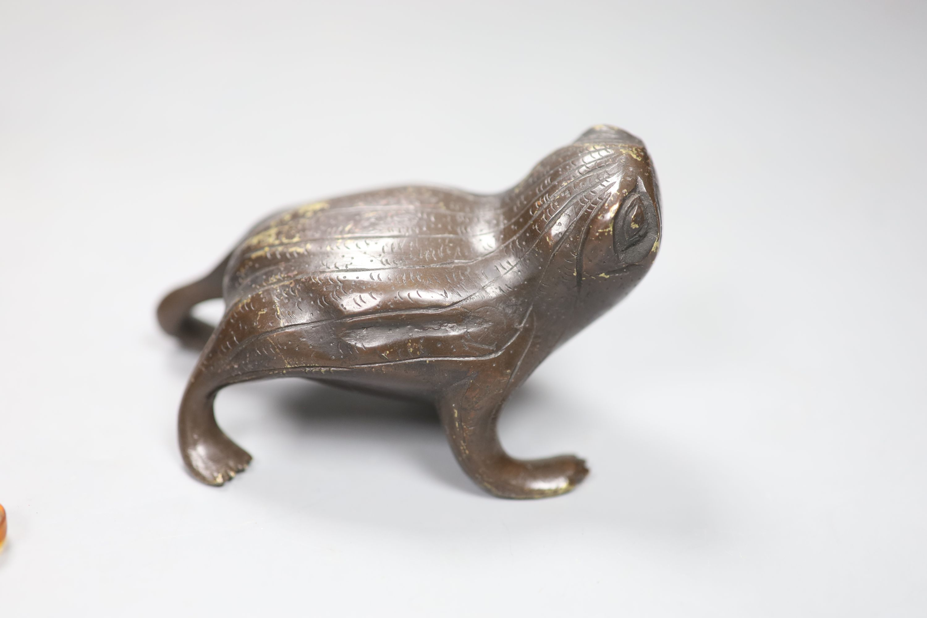 A Chinese bronze toad, a wood figure of an immortal and a woven basket and cover